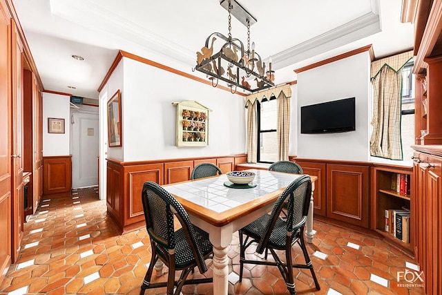 dining room featuring an inviting chandelier, ornamental molding, and light tile patterned flooring