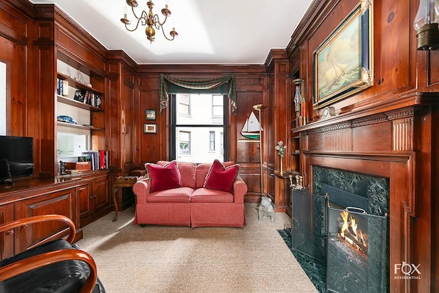 home office with built in shelves, carpet, a fireplace, and wood walls