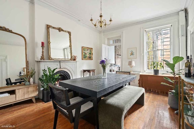 dining room featuring hardwood / wood-style flooring, ornamental molding, and an inviting chandelier