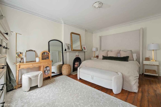 bedroom with ornamental molding and dark hardwood / wood-style floors