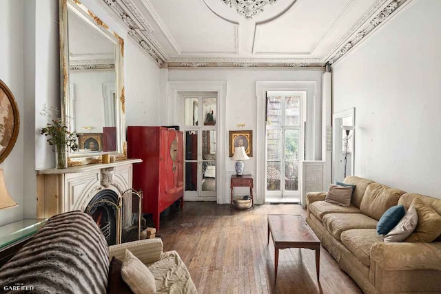 sitting room with crown molding and hardwood / wood-style flooring