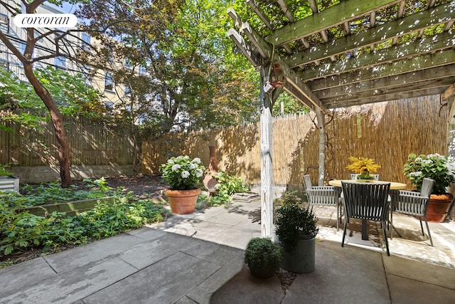 view of patio with a pergola, outdoor dining area, and fence