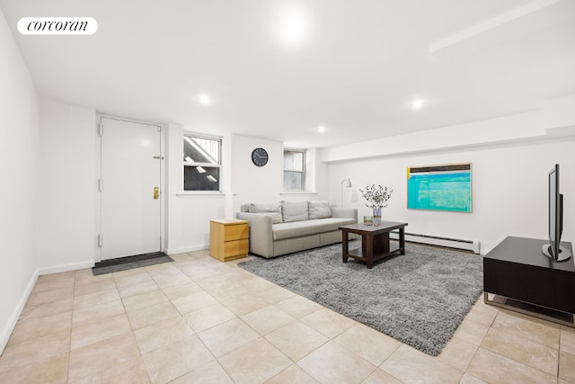 living room with light tile patterned floors and a baseboard radiator