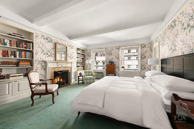 bedroom with a premium fireplace, beam ceiling, and carpet floors