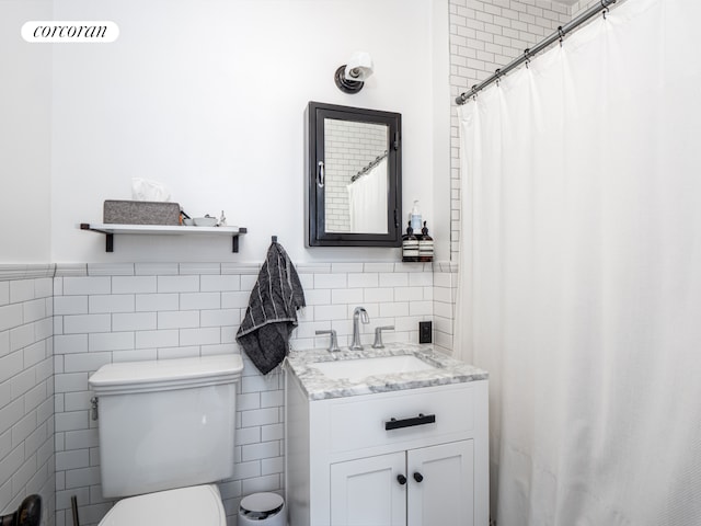 54 W 71st Street Building, New York City, NY 10023 - bathroom with tile walls, toilet, vanity, and wainscoting