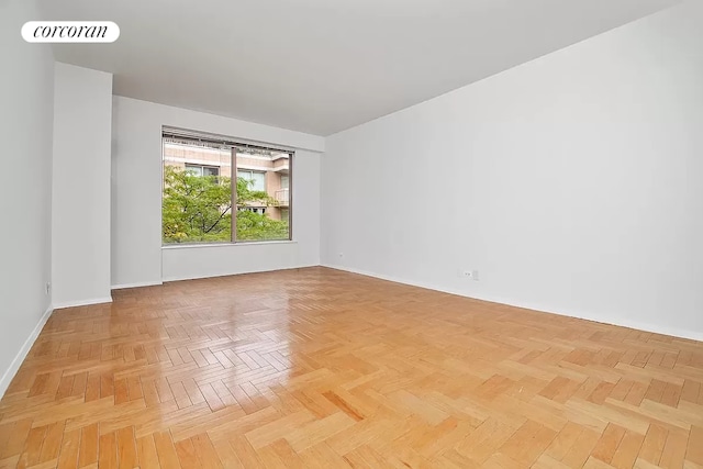 spare room with light parquet floors