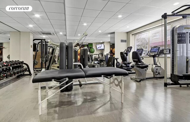 exercise room featuring a paneled ceiling