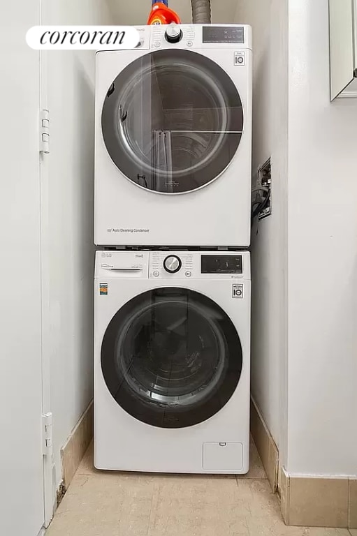 laundry room with stacked washing maching and dryer