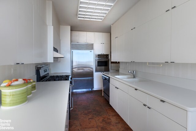 kitchen featuring white cabinetry, stainless steel appliances, sink, and backsplash