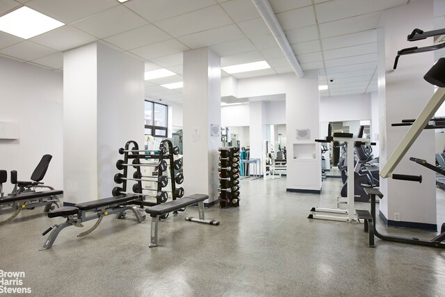 gym with a paneled ceiling