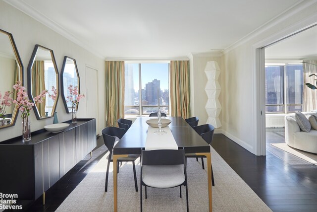 dining space featuring dark hardwood / wood-style flooring and ornamental molding