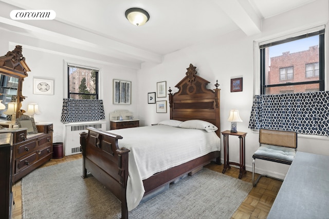 bedroom featuring dark parquet flooring, radiator heating unit, and beam ceiling