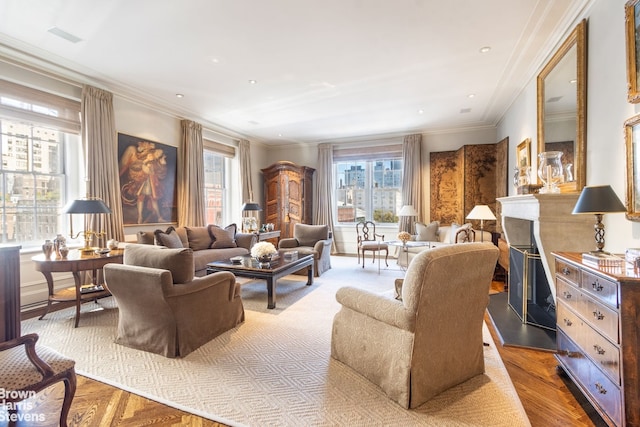 living room with ornamental molding, plenty of natural light, a fireplace, and wood finished floors