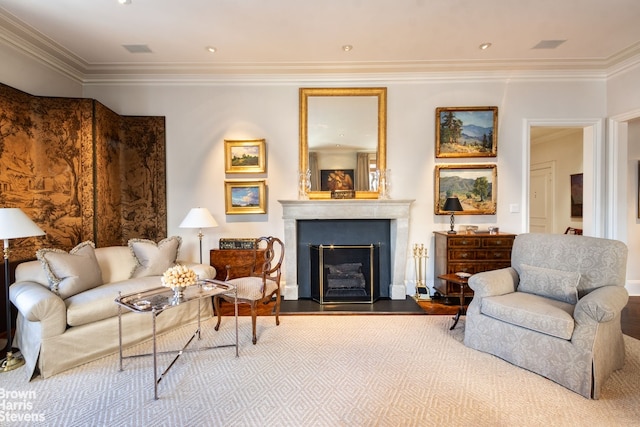 living area featuring ornamental molding, a fireplace with raised hearth, visible vents, and wood finished floors