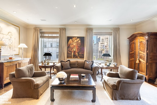 sitting room featuring ornamental molding and light wood-style flooring