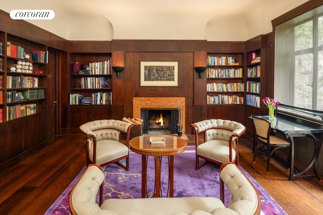 49 E 80th St, New York City, NY 10075 - living area featuring a warm lit fireplace, visible vents, built in shelves, and wood finished floors