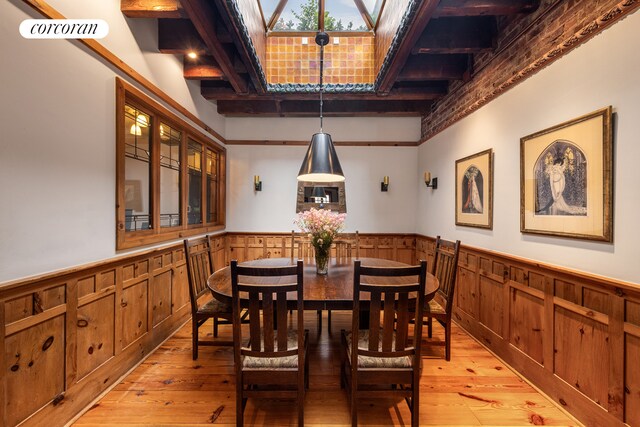 49 E 80th St, New York City, NY 10075 - dining area with light wood-type flooring and wainscoting