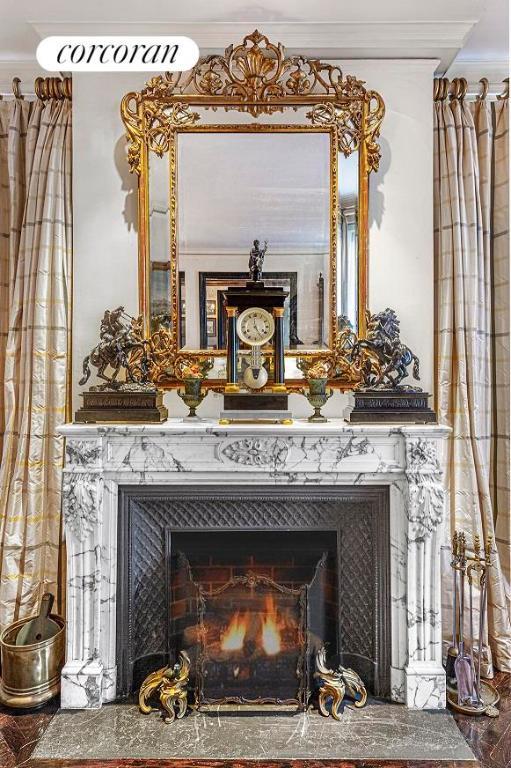 room details featuring ornamental molding and a fireplace