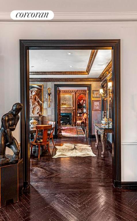 corridor featuring dark parquet flooring and ornamental molding