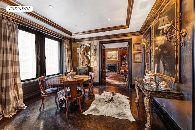 dining space with a fireplace, a wood stove, and ornamental molding