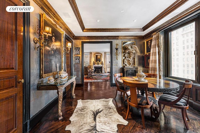 dining room with a wood stove, a wealth of natural light, and crown molding