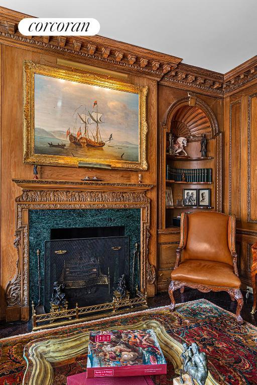 sitting room featuring built in features and a fireplace