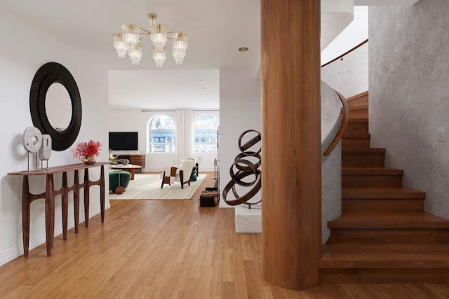 stairway featuring wood-type flooring and an inviting chandelier