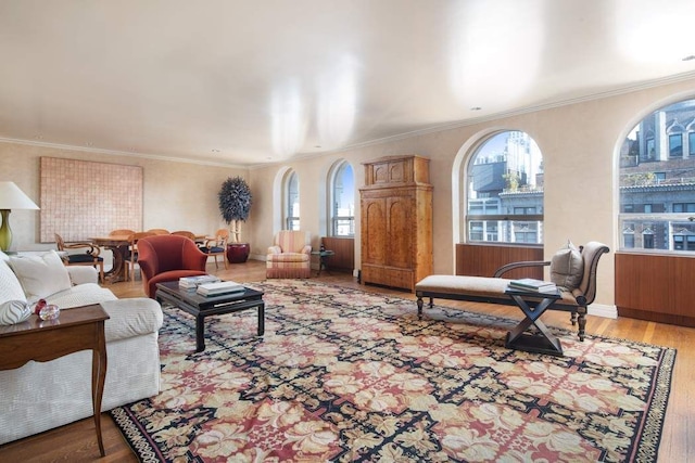 living room featuring hardwood / wood-style floors and crown molding