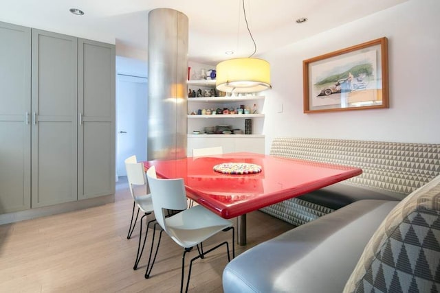 dining space with built in shelves, light hardwood / wood-style flooring, and breakfast area