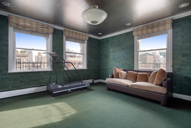 living area with a wealth of natural light, carpet, and ornamental molding