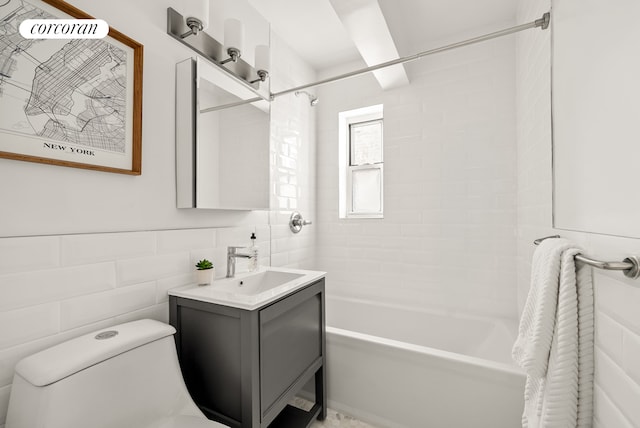 bathroom with shower / washtub combination, tile walls, toilet, and vanity