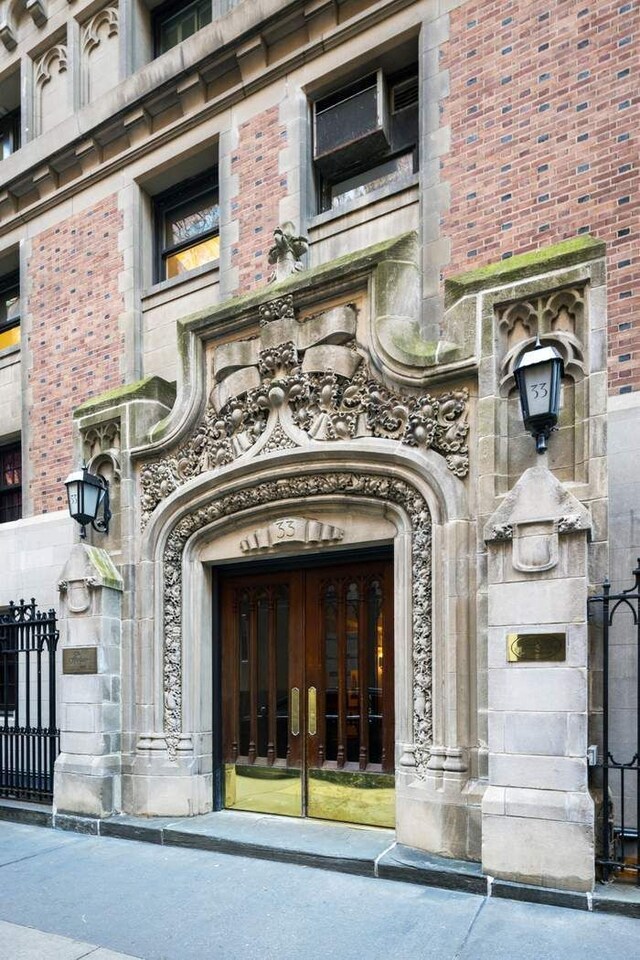 33 W 67th St Unit 6Fe, New York City, NY 10023 - entrance to property featuring stone siding, french doors, and brick siding