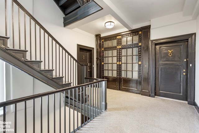 hallway featuring tile walls, crown molding, and a chandelier