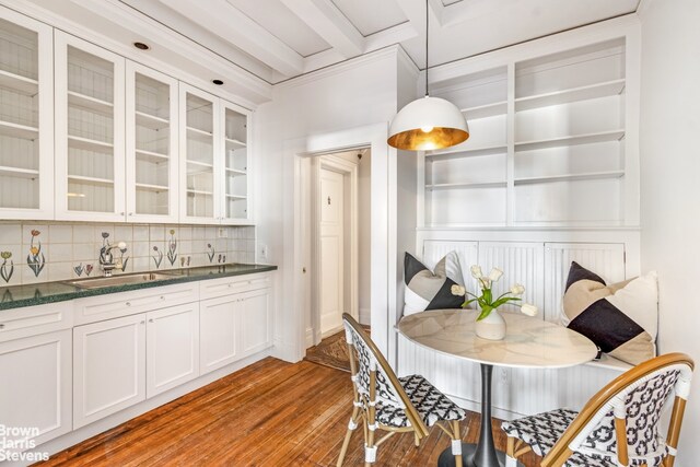 hall with tile walls, crown molding, and an inviting chandelier