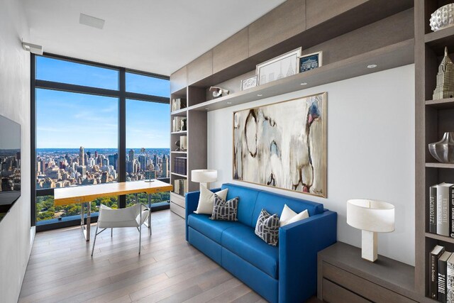 bedroom featuring floor to ceiling windows and hardwood / wood-style floors