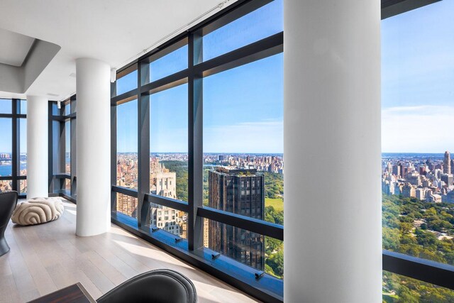 bedroom featuring floor to ceiling windows and dark wood-type flooring