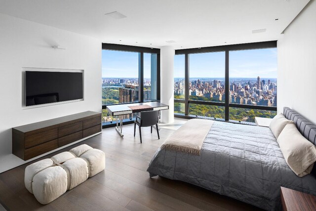 dining space featuring plenty of natural light, hardwood / wood-style floors, and a wall of windows