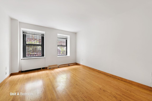 spare room with light hardwood / wood-style flooring