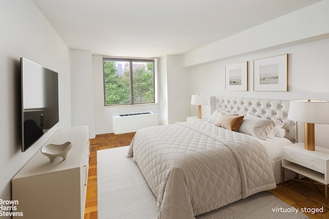 bedroom with parquet flooring and radiator heating unit