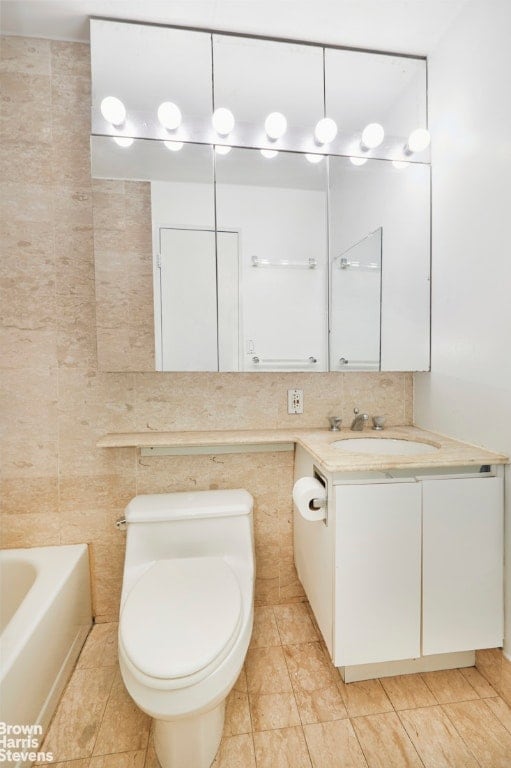 bathroom with decorative backsplash, tile walls, toilet, and vanity