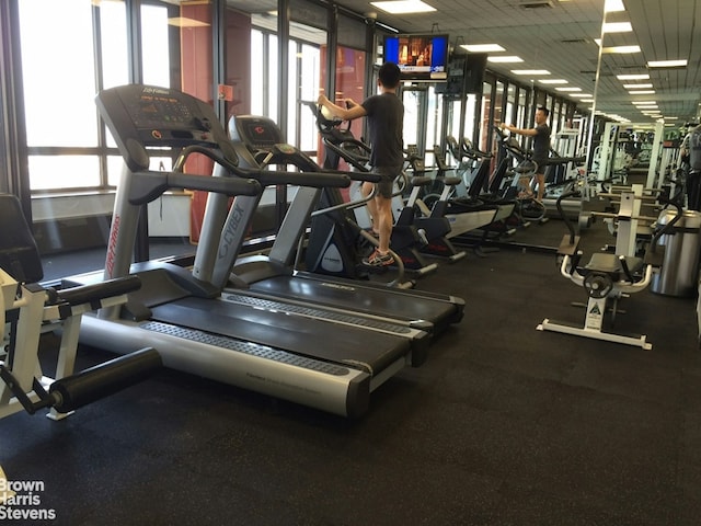 workout area featuring a paneled ceiling