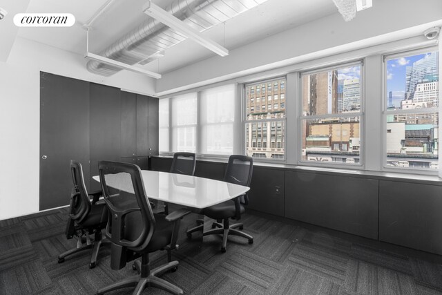 interior space featuring beamed ceiling and an AC wall unit