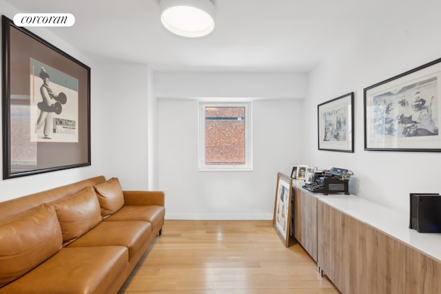 office with light wood-style floors, visible vents, and baseboards