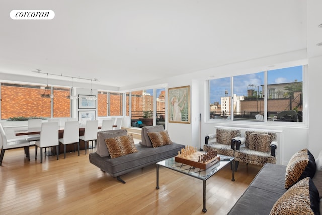 living room with hardwood / wood-style floors, visible vents, and a city view