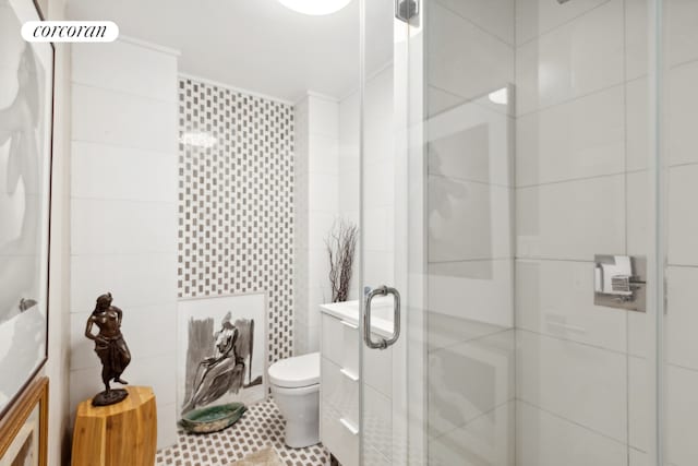 full bath featuring toilet, a shower stall, and tile walls