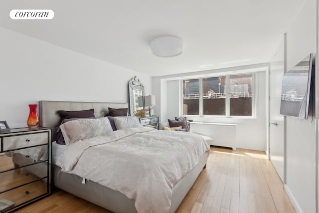 bedroom featuring light wood finished floors and visible vents