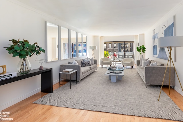 living room with hardwood / wood-style floors and ornamental molding