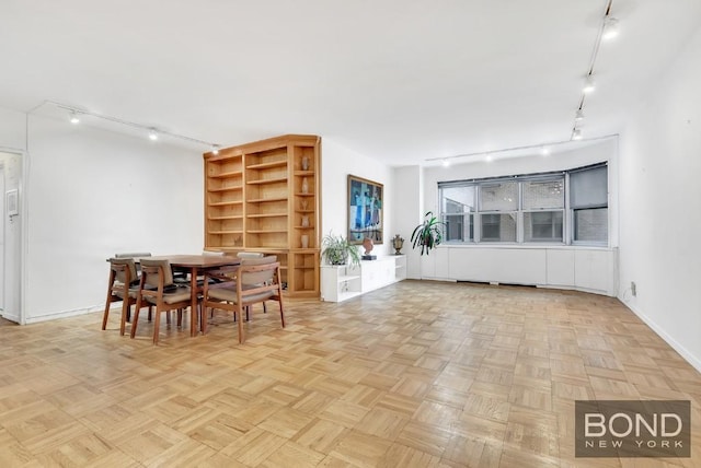 dining space with light parquet flooring