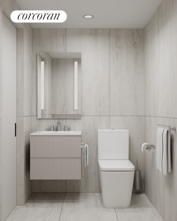 bathroom featuring toilet and vanity