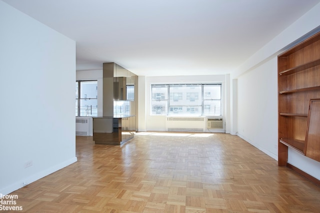 unfurnished living room with light parquet flooring and radiator